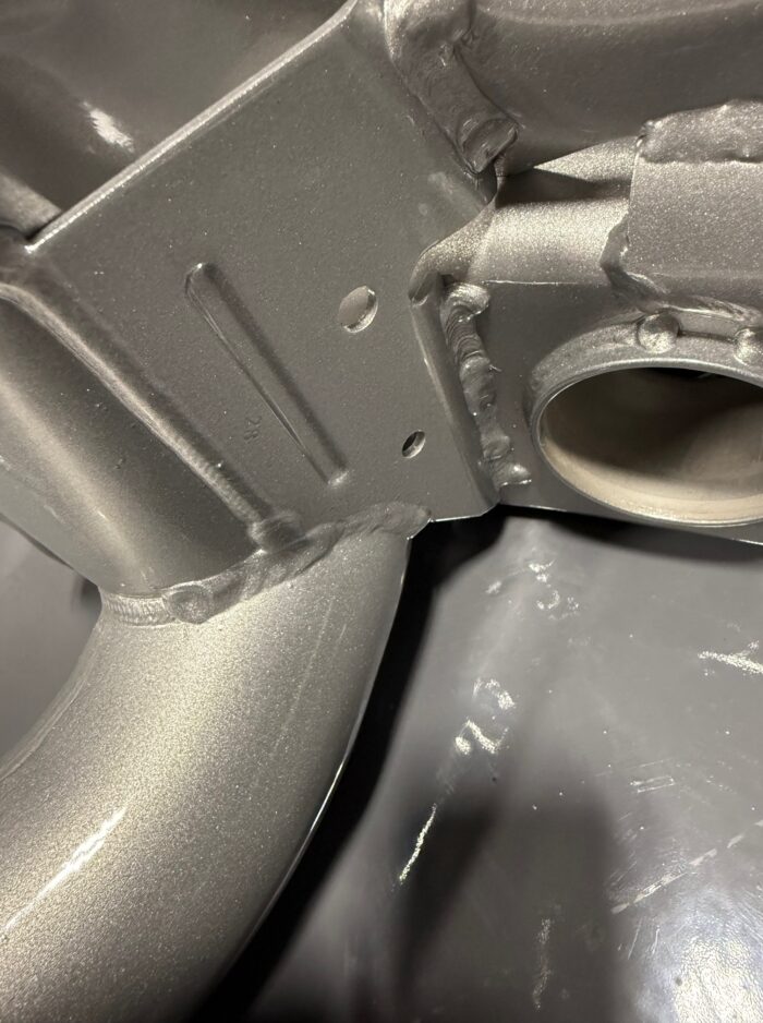 Close-up of BMW E39 M5 subframe with fully TIG-welded bracket and metallic silver powdercoat