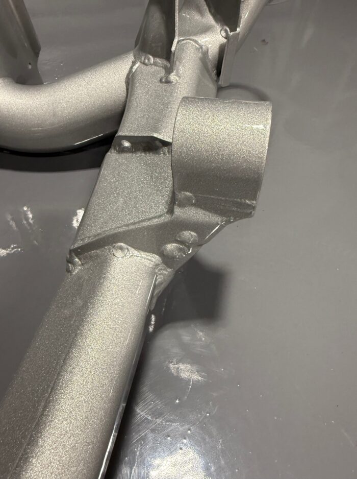 Close-up of reinforced BMW E39 M5 rear subframe with TIG-welded front differential mount and silver powdercoat finish
