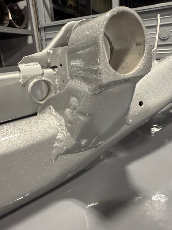 Reinforced front differential mount on BMW E39 M5 subframe with TIG welds and silver powdercoat
